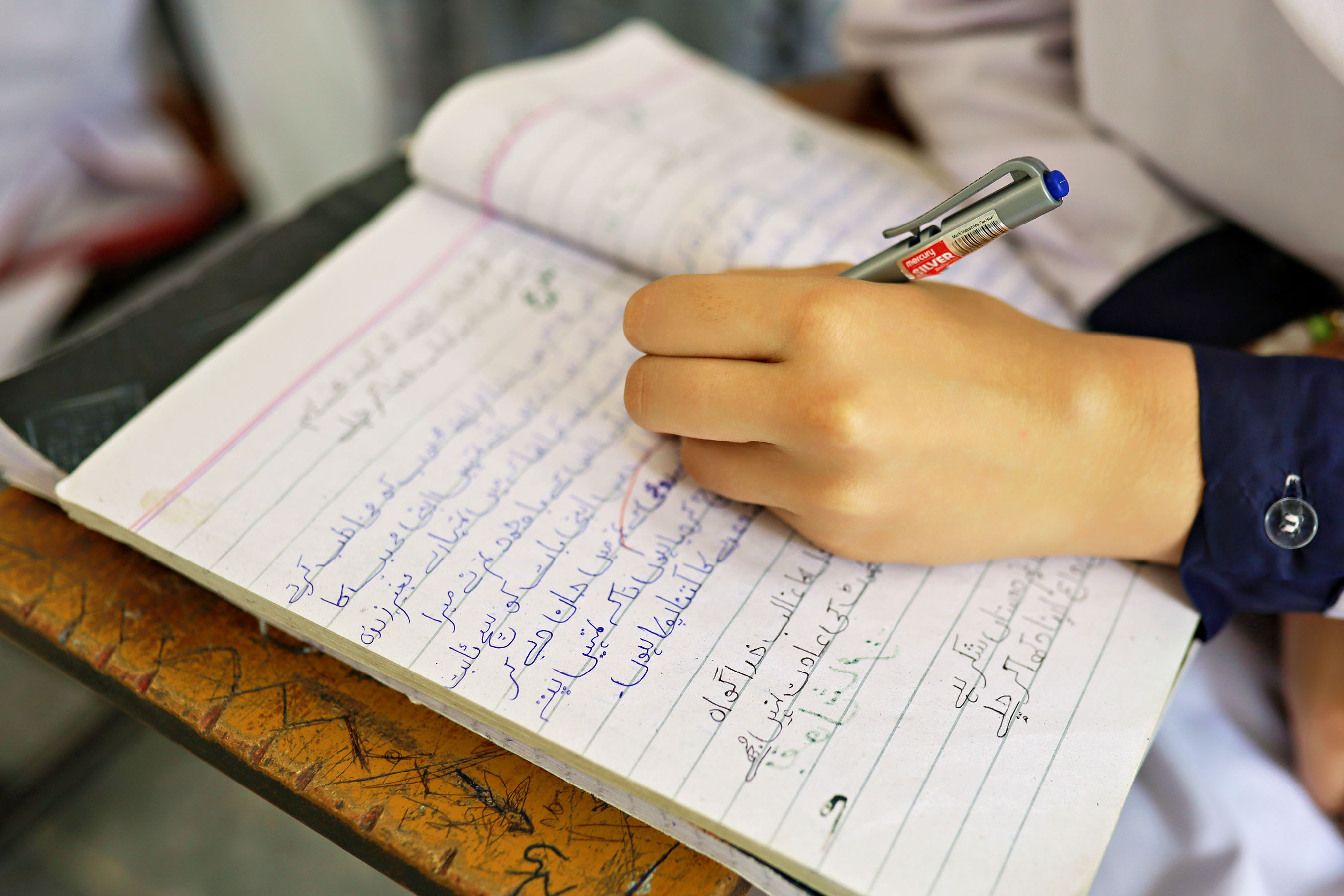 A student's handwriting in an exercise book during class